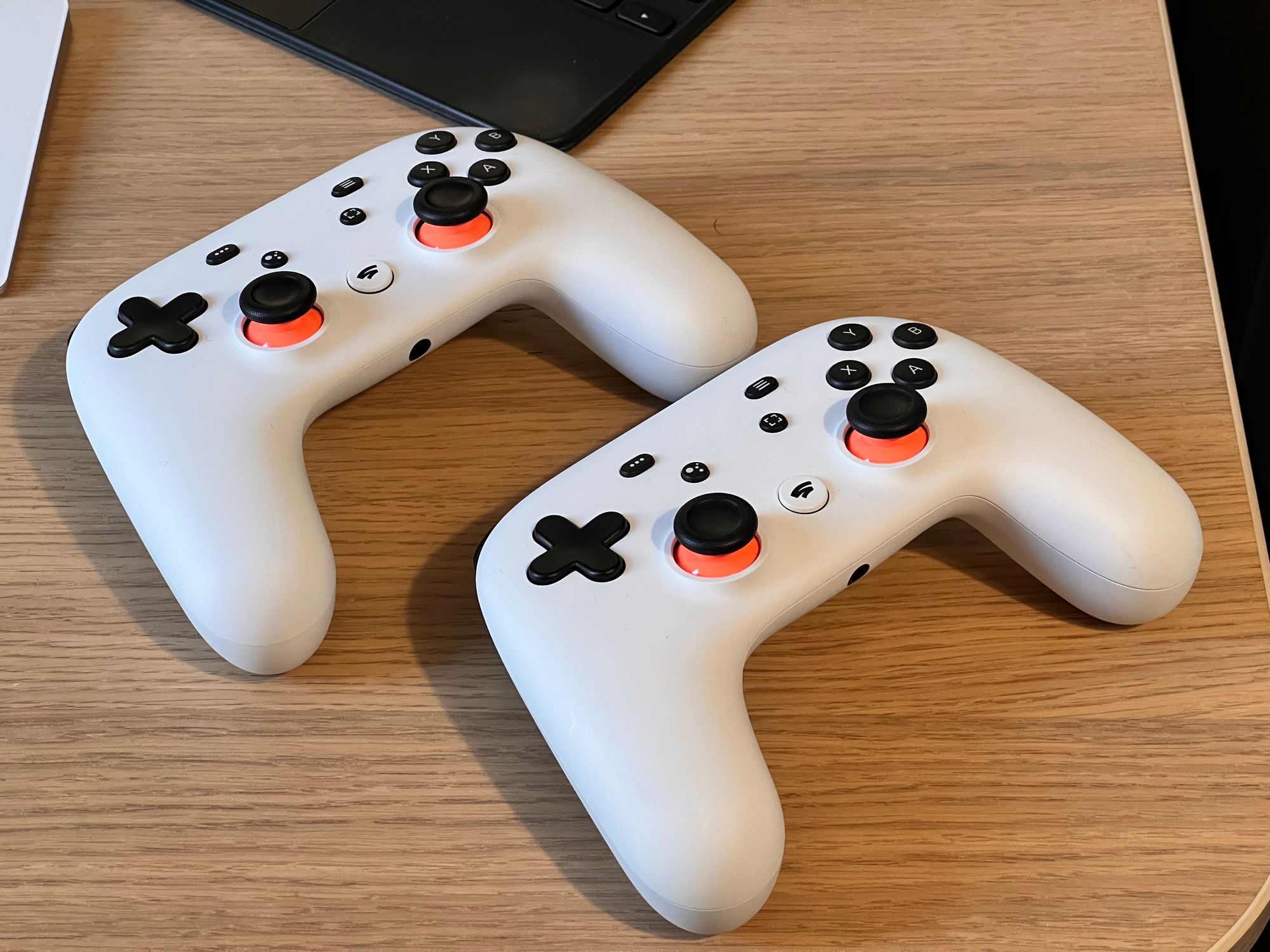 Two white Stadia controllers